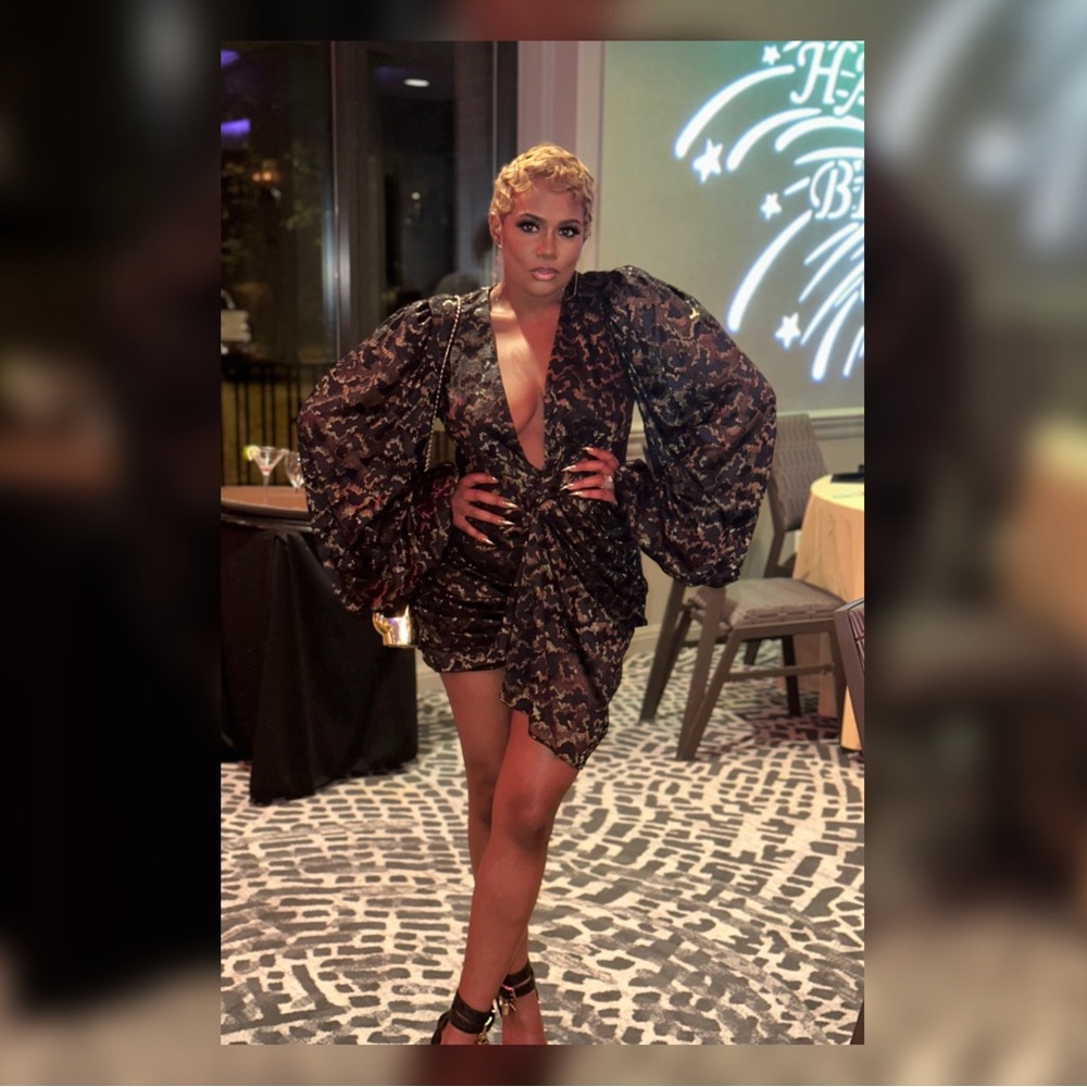 Black and gold ballon sleeve cocktail dress with deep plunge